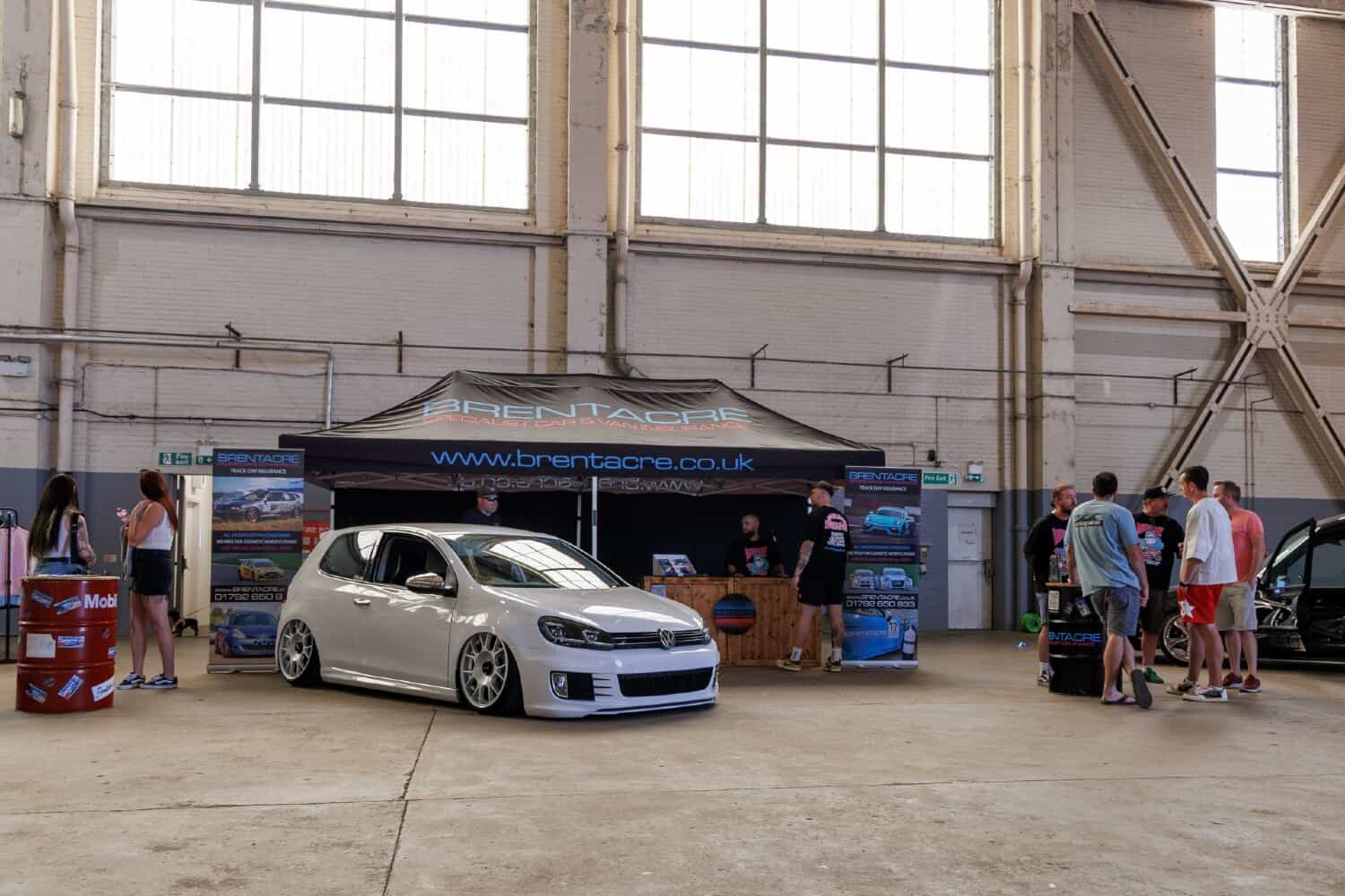 The Brentacre stand at a UK car show with a modified Volkswagen Golf GTI on display