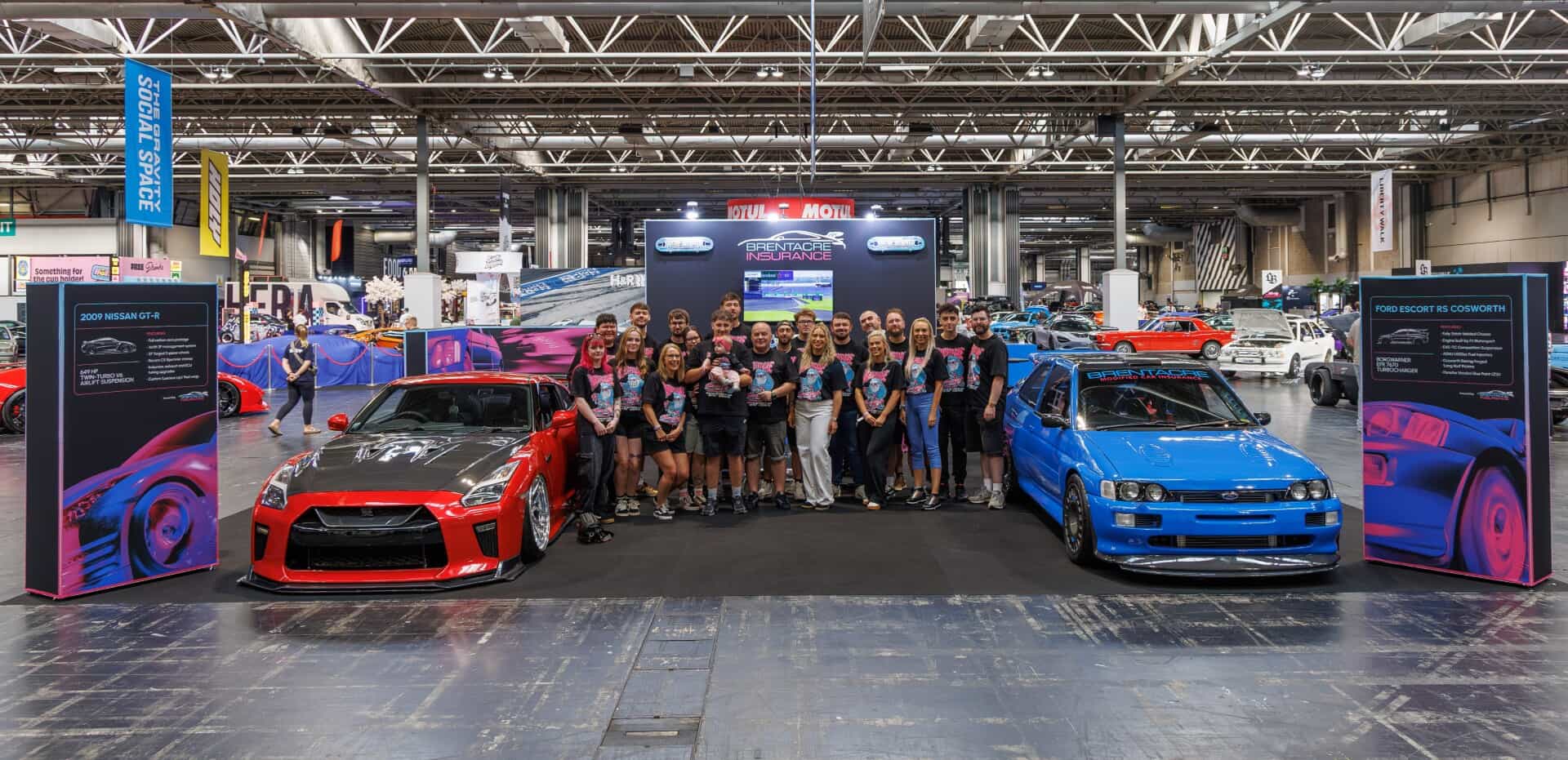The Brentacre team on their stand at a UK car show, with a modified Nissan GT-R and a Ford Escort RS Cosworth